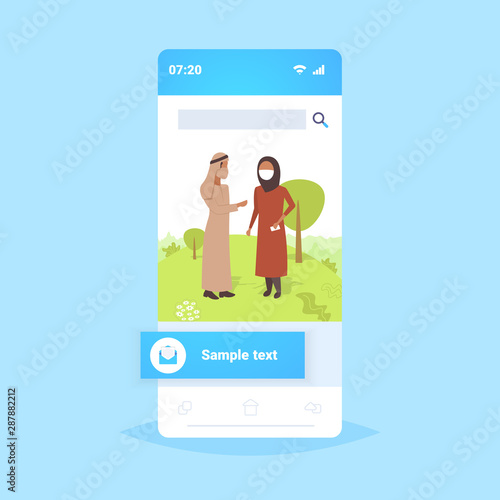 arab couple wearing face mask plant pipe dirty waste toxic air pollution industry smog polluted environment concept arabic man woman walking outdoor smartphone screen full length flat