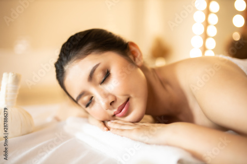 Asian Beautiful  young and healthy woman in spa salon. Massage treatment spa room  . Traditional medicine and healing concept.