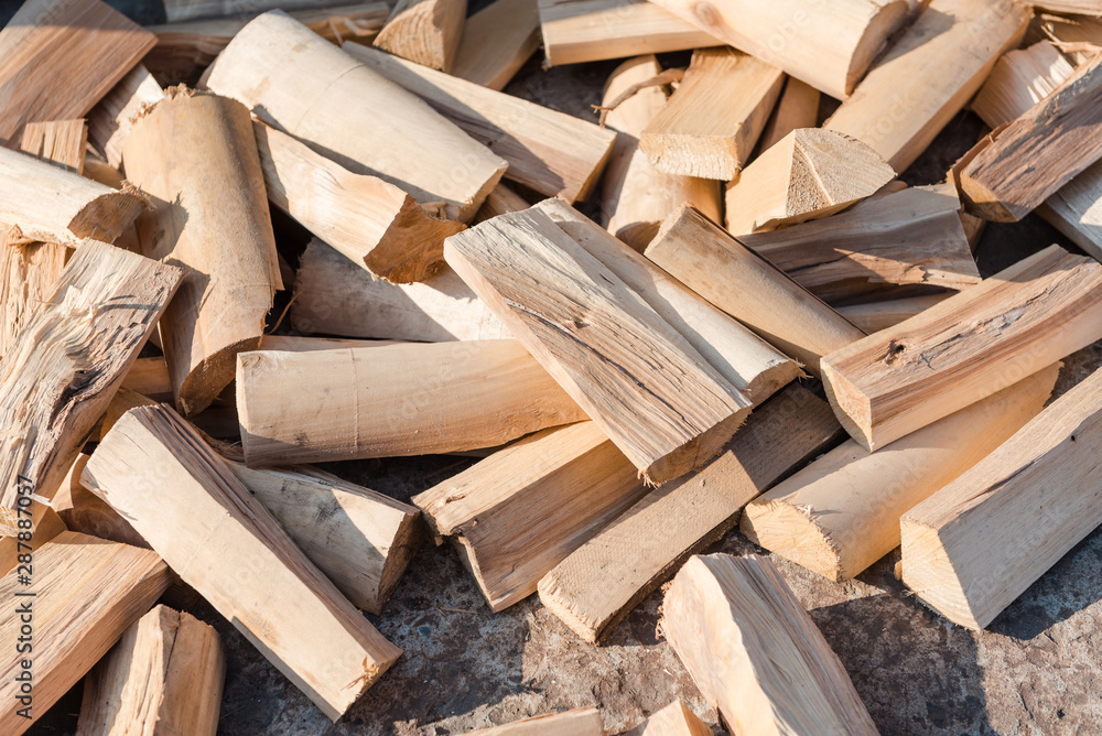 chopped firewood. firewood is on the ground. solid fuel. preparation of firewood for the winter. sawn tree. chopped firewood. firewood is on the ground. solid fuel. preparation of firewood for the winter. sawn tree.