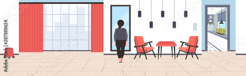 fat overweight businesswoman looking at reflection in mirror sad obese girl unhealthy lifestyle obesity concept modern office interior horizontal flat rear view full length