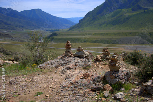 A sacred stone cairn on top of a mountain overlooking the valley. photo