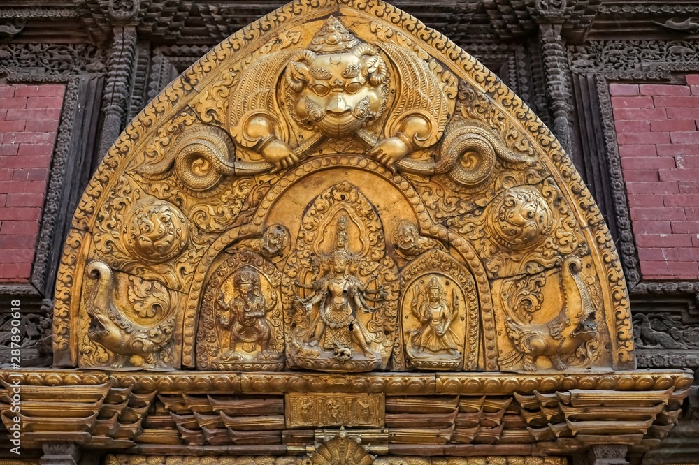 Various embodiment of Hindu Gods carved on a metal plate in Patan Durbar Square.