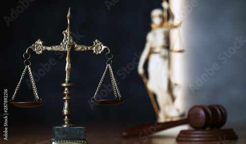 Law and Justice, judge gavel, book with Statue of blind goddess Themis on wooden table.