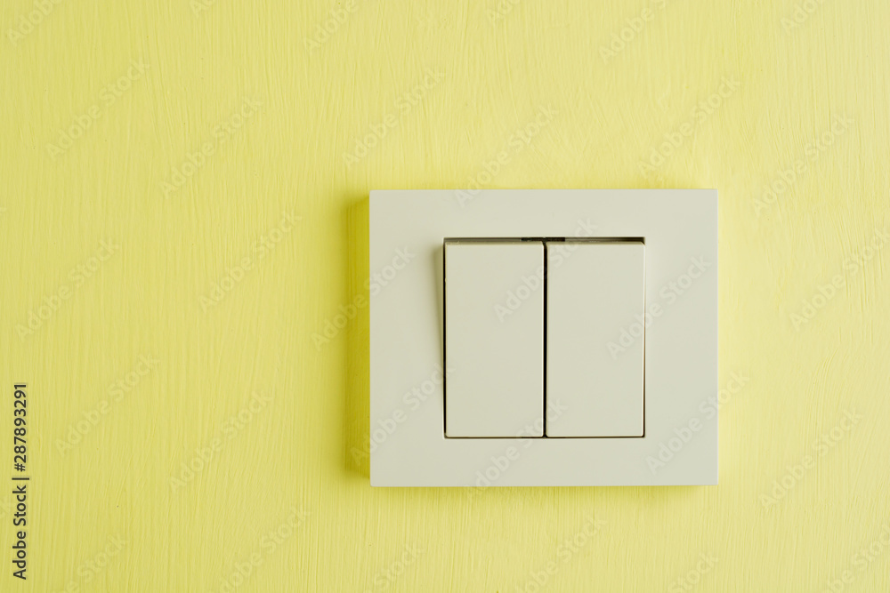 Electric switch with space for text on yellow wall. Electric switch with space for text on yellow wall.