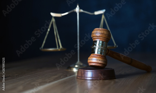 Law and Justice, judge gavel with scales on wooden table.