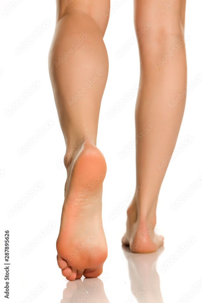 Beautifully groomed female feet on a white background Beautifully groomed female feet on a white background