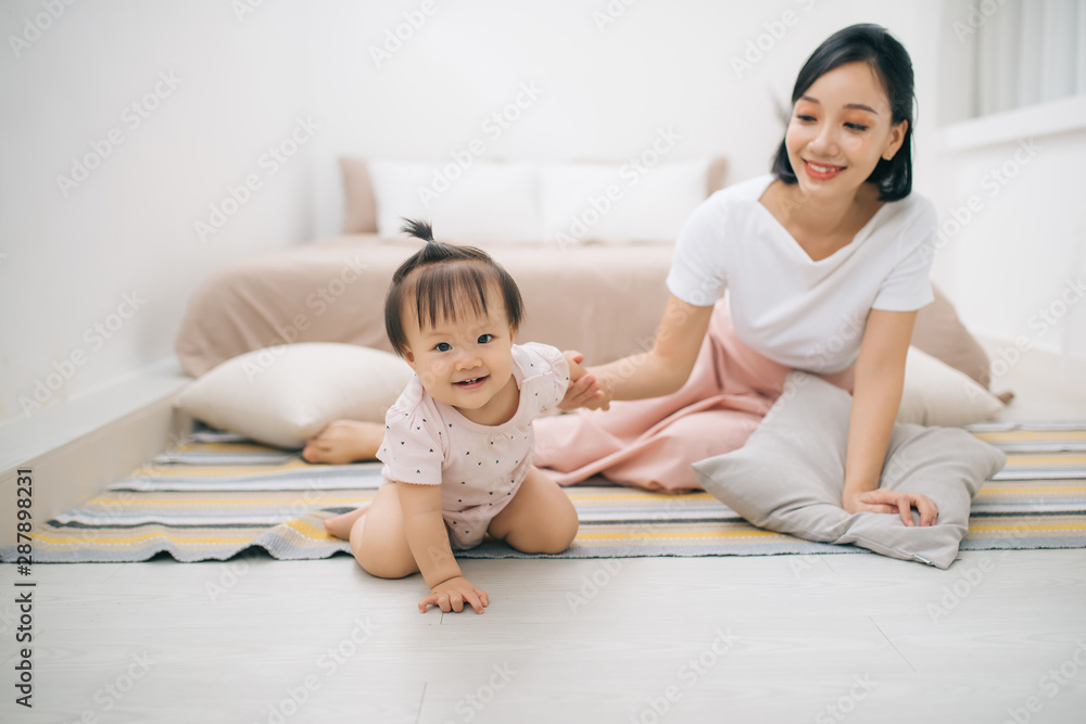 asian mother and child relaxing on the bed room asian mother and child relaxing on the bed room