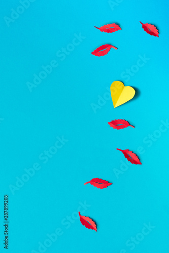 Paper Autumn leaves, flat lay on blue paper background, copy-space