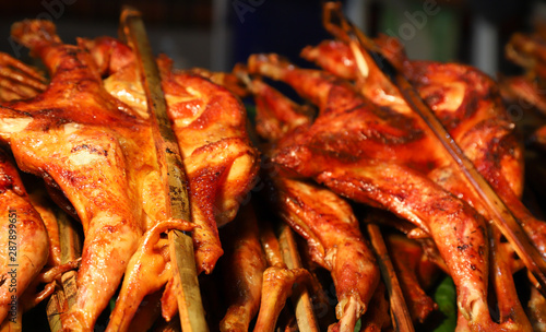 Closeup of grilled chicken show for selling. A famous Asian street food. 
