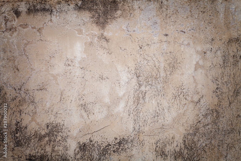 Obraz premium Old beige wall covered with uneven plaster. Texture of vintage shabby sand brick surface, closeup.