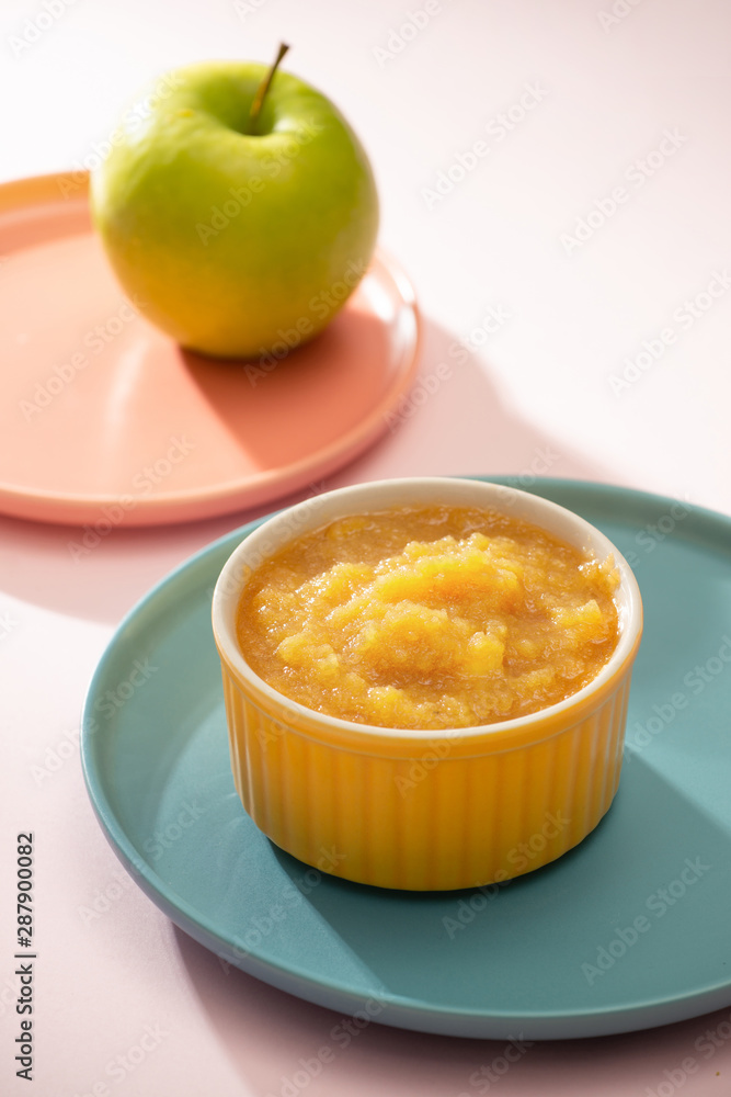 Natural baby food concept. Bowl of apple baby puree. Natural baby food concept. Bowl of apple baby puree.
