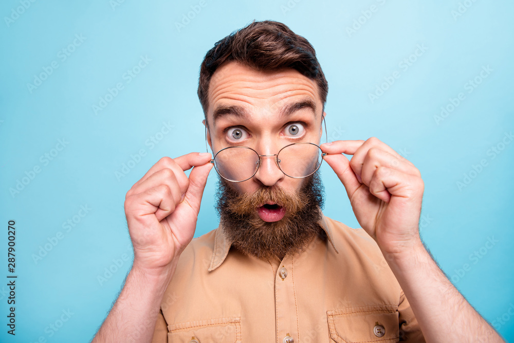 Φωτογραφία Close up photo of astonished youth touching her specs wearing brown shirt isolat