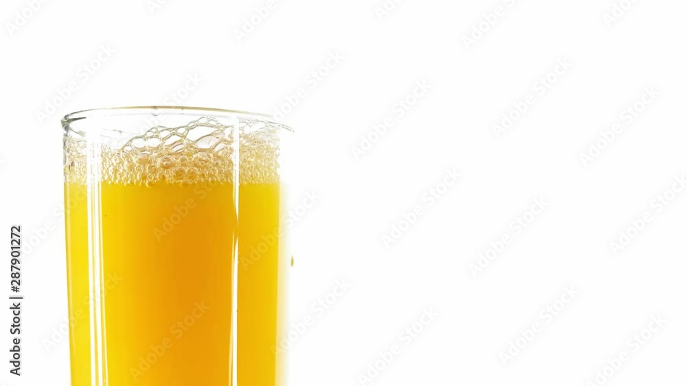 Orange Juice being Poured A Tall Glass Against White Background. Concept Of: Diet, Healthy Drinks Vitamins, Vegetarian Orange Juice being Poured A Tall Glass Against White Background. Concept Of: Diet, Healthy Drinks Vitamins, Vegetarian