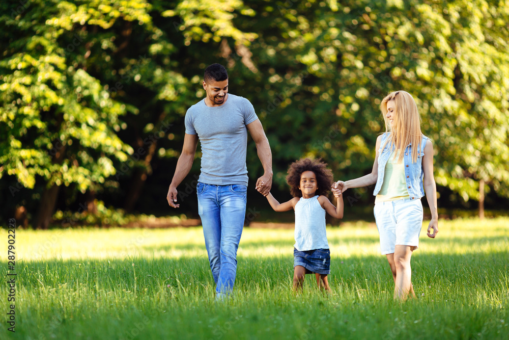 Obraz premium Happy young couple spending time with their daughter