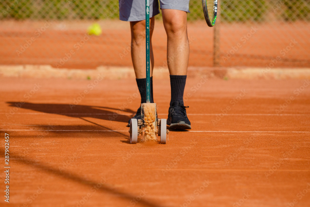 unrecognizable man with sweeps lines of tennis court