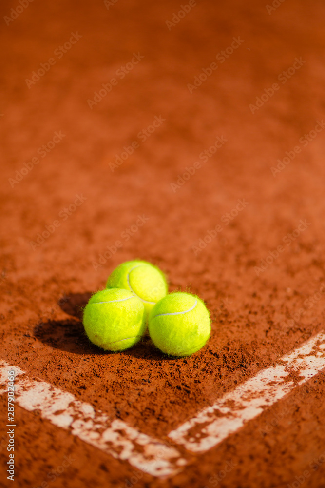 three tennis balls on the court