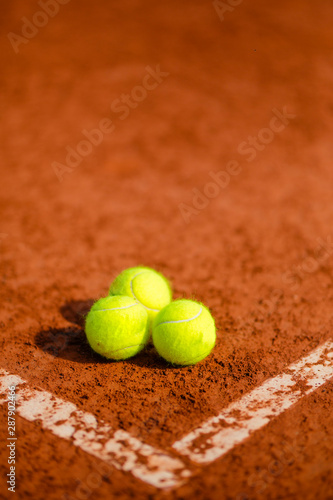 three tennis balls on the court