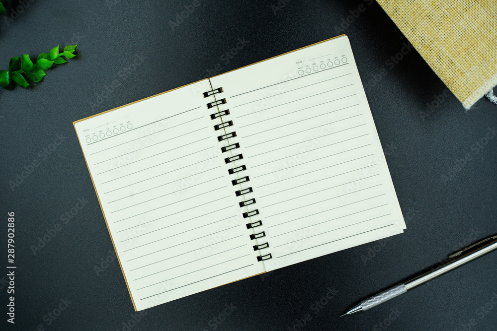 blank notebook on black background blank notebook on black background