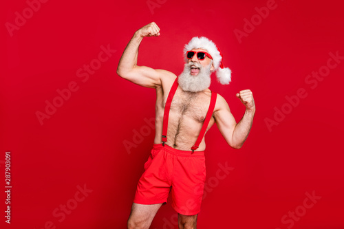 Portrait of his he nice attractive content powerful bearded gray-haired man crossfit trainer instructor bodybuilder showing biceps triceps fit acre isolated over bright vivid shine red background