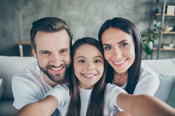 Self-portrait of nice attractive lovely sweet winsome charming cheerful cheery idyllic adopted foster family mommy daddy enjoying life holiday indoors house apartment