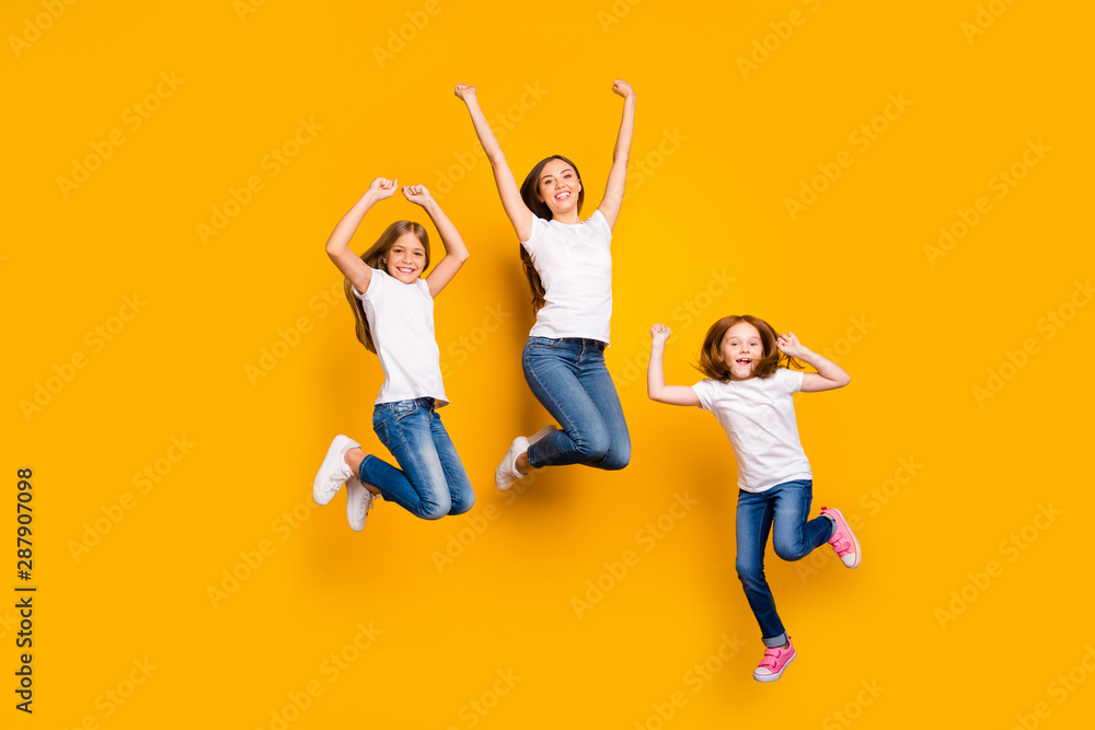 Full body photo of three ladies jumping high spending weekend wear casual clothes isolated yellow background