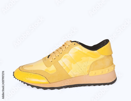 yellow sneakers on yellow background