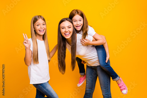 Photo of crazy three ladies showing v-sign playful weekend wear casual clothes isolated yellow background photo
