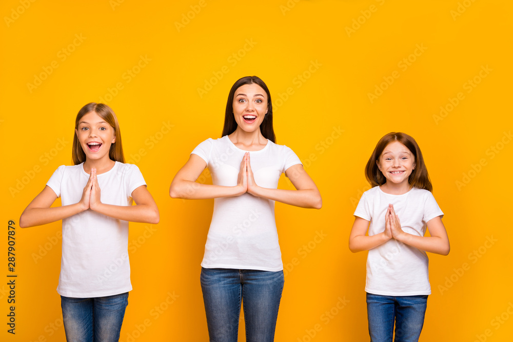 Photo of three ladies holding hands together want some help wear casual white t-shirts isolated yellow background Photo of three ladies holding hands together want some help wear casual white t-shirts isolated yellow background