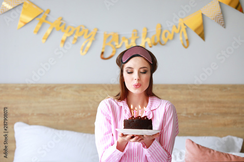 Happy woman blowing out can...