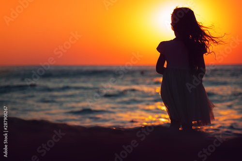 Little girl playing on the beach