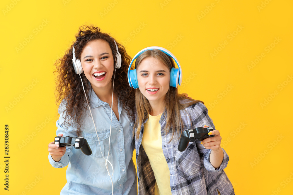 Teenagers playing video game on color background Teenagers playing video game on color background