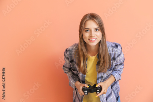 Teenage girl playing video ...