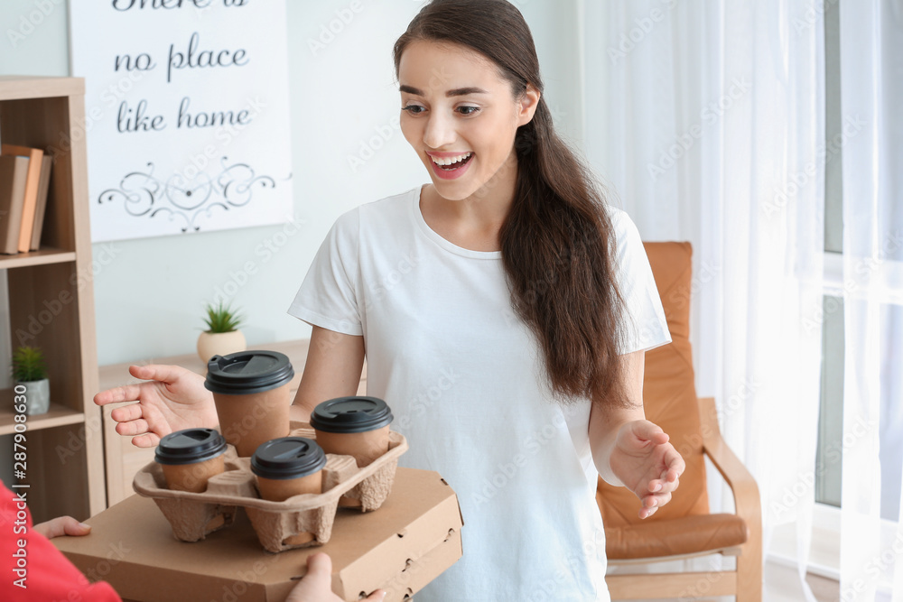 Woman receiving order from courier of food delivery company Woman receiving order from courier of food delivery company
