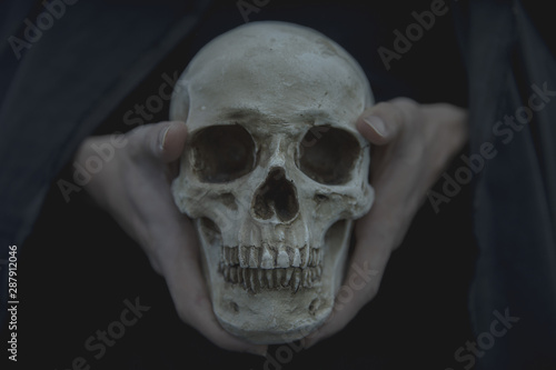 Close-up front view of skull being held by man