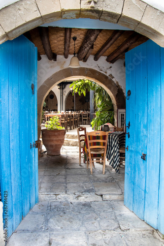 blue door entrance to the traditional tavern in small village on cyprus