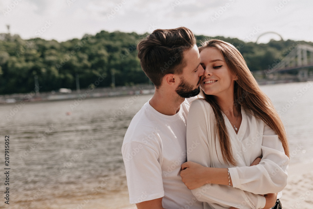 Couple in love, enjoying the summer time near the lake. Close up of smiling couple Couple in love, enjoying the summer time near the lake. Close up of smiling couple