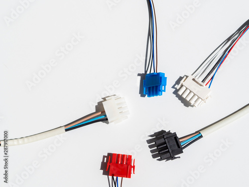 Flat lay frame with colorful wire connectors and wires on a white background