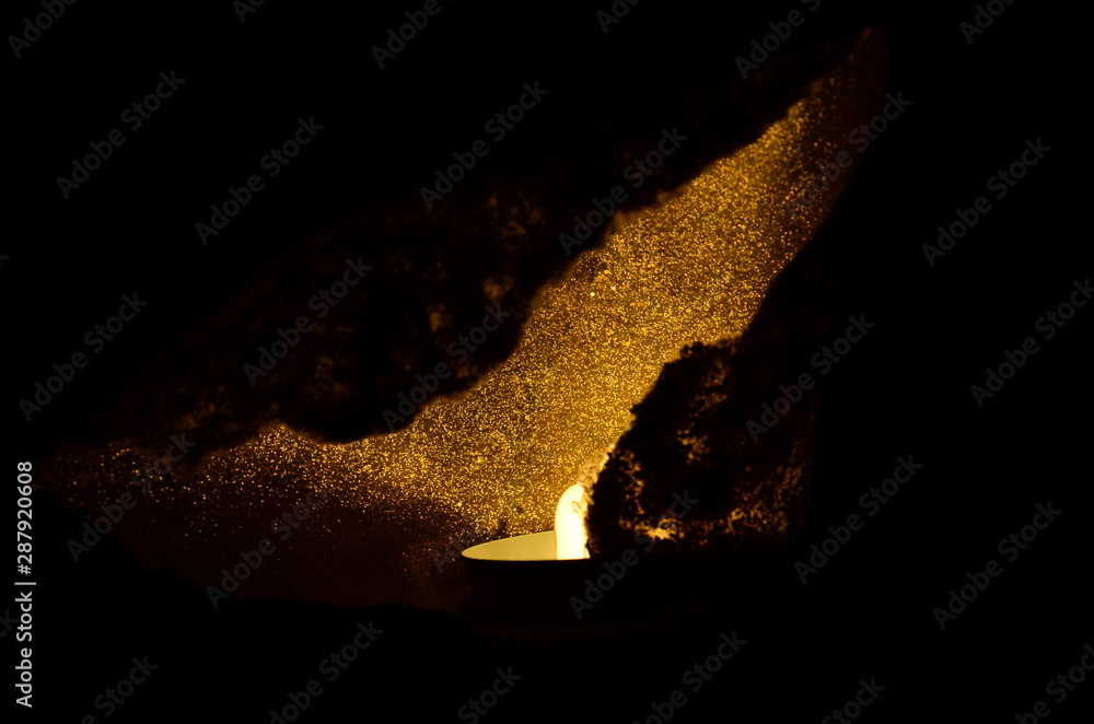 Fototapeta premium burning candle on black background