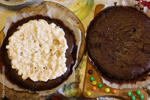 chokolate dough for cake in cooking process with murshmellow filling and colored sweets photo