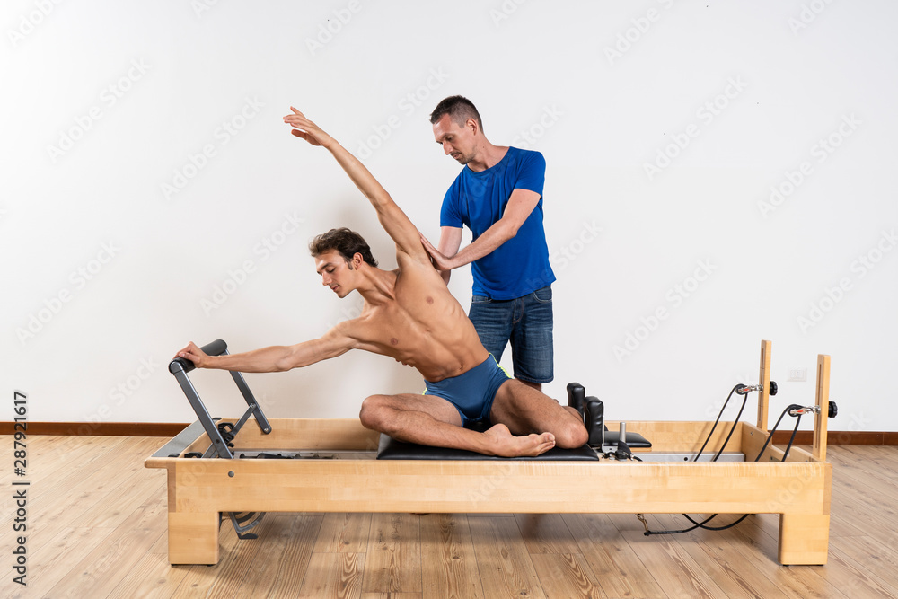 Pilates exercise on the reformer machine Pilates exercise on the reformer machine