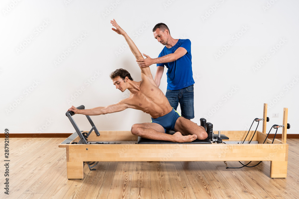 Pilates exercise on the reformer machine Pilates exercise on the reformer machine