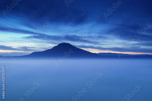 Mountain view misty morning of top hill around with ocean of mist with cloudy sky background, sunrise at Khao Takhian (takian) Ngo, Khao Kho, Phetchabun, Thailand. photo