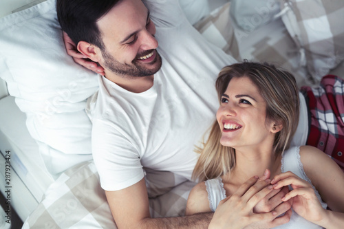 Young couple having romantic time in bedroom