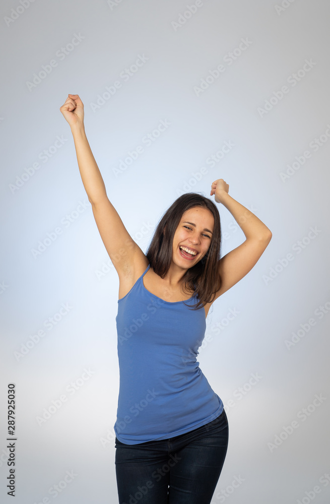 Cute beautiful teenager girl dancing feeling happy celebrating success or winning Cute beautiful teenager girl dancing feeling happy celebrating success or winning