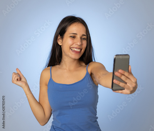 Young teenager woman taking selfie with mobile smart phone for social media