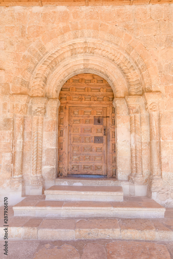 Exterior door, columns and reliefs, in church of Santa Maria del Rivero, romanic style landmark and public monument from twelfth century, in San Esteban de Gormaz, Soria, Spain, Europe