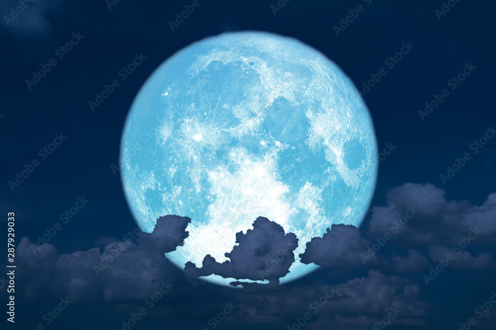 blue strawberry moon back on silhouette heap cloud on sunset sky
