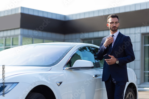 Businessman standing near white car in the morning © zinkevych