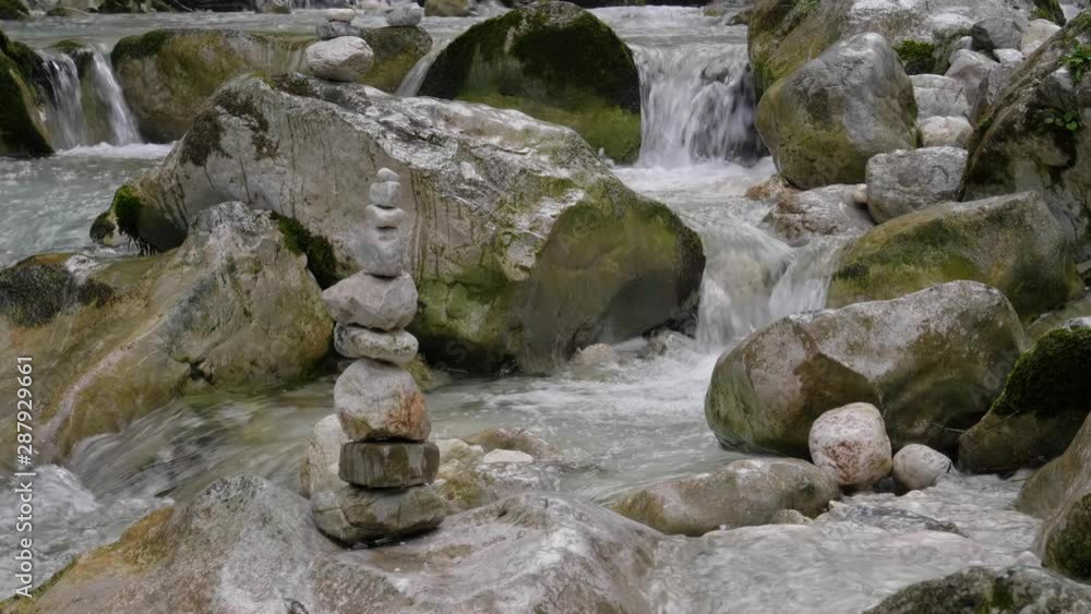 Figures of stones in the middle of a stormy stream Figures of stones in the middle of a stormy stream