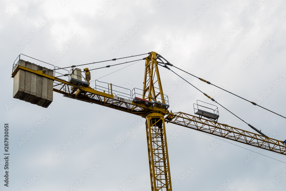 yellow construction crane against blue sky yellow construction crane against blue sky
